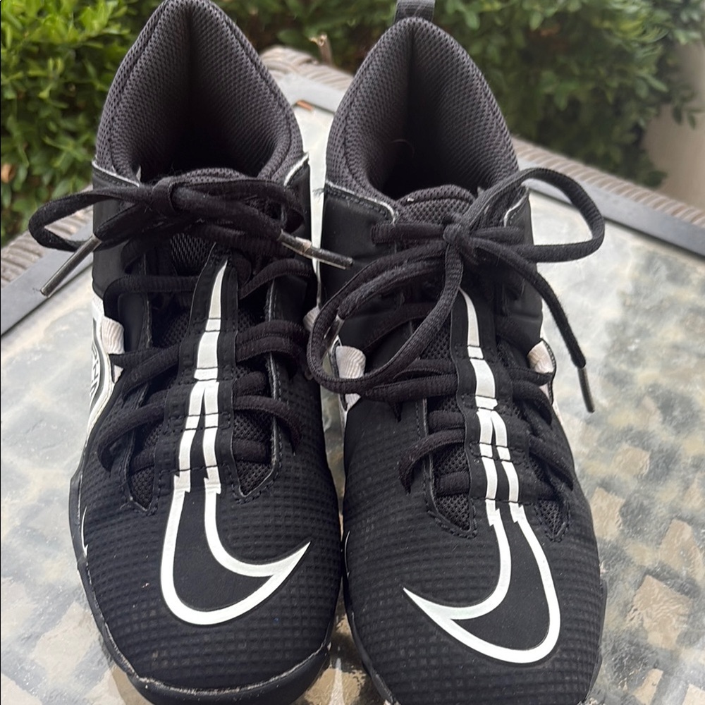Boys Black Athletic Cleats with White Nike Emblem